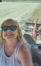 Sheri fluffing hay